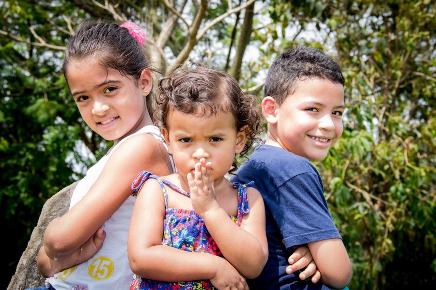 Three children posting for the camera.